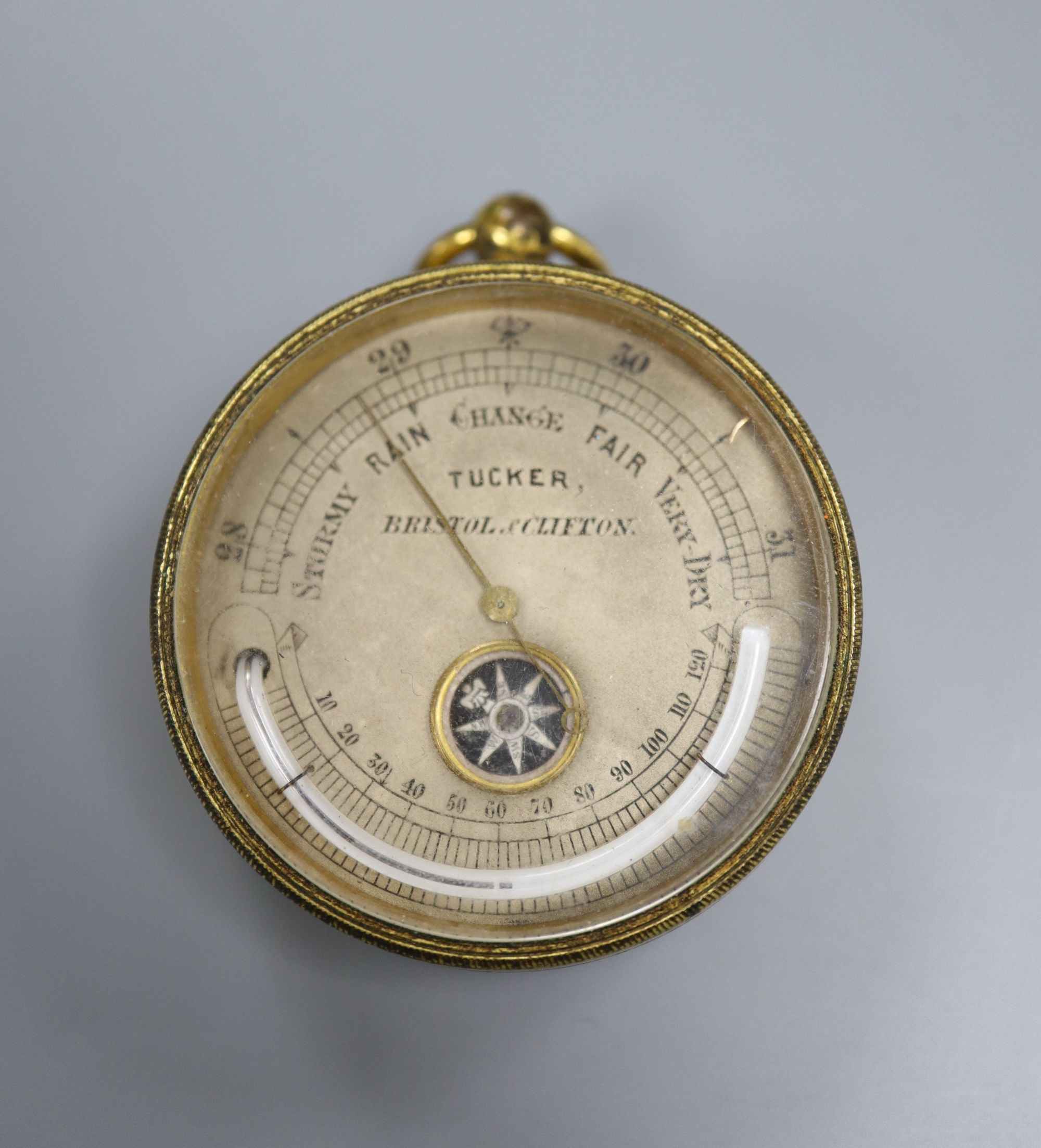 A late 19th century gilt brass compensated barometer, combined thermometer and compass, by Tucker of Bristol and Clifton, 42mm.